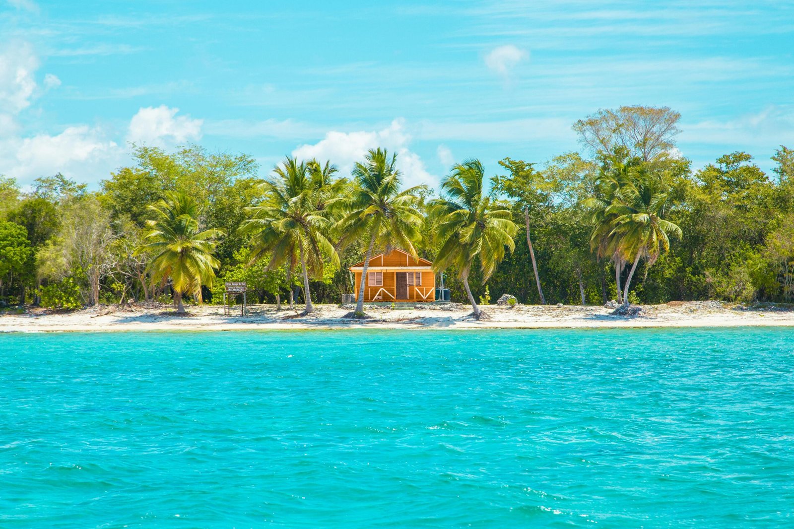 pexels-photo-2598683-2598683 Idyllic cabin on a tropical beach in La Altagracia, Dominican Republic, surrounded by palm trees and turquoise waters.
